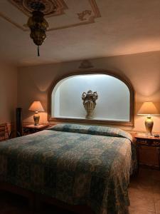 a bedroom with a large bed with a large window at Hotel Posada Maria Bonita in Bernal