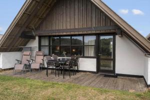 a patio with a table and chairs on a house at 531-Lemvig-Lokkevej-59-C in Lemvig