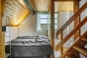 a small bedroom with a bed and a window at 531-Lemvig-Lokkevej-59-C in Lemvig