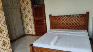 a bed with a white towel laying on it at 2bedrooms in Nyali close to the beach in Mombasa in Mombasa +9 photos