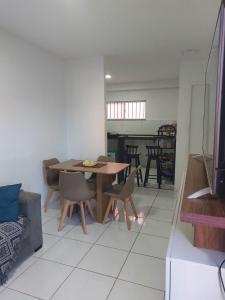 a dining room with a wooden table and chairs at Andrea in Petrolina
