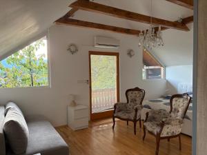 a living room with a couch and chairs and a table at Apartments Nina in Bled