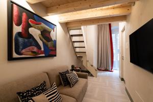 a living room with a couch and a flat screen tv at Le Dimore di Rosa e Vincenzo in Bari