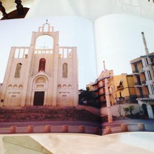 an open book with a picture of a church at B&B Santiago in Gela