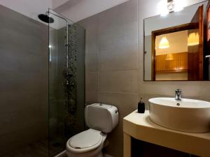 a bathroom with a toilet and a sink and a shower at Marili Apartments in Roda +54 photos