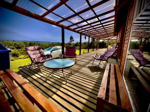 a patio with chairs and a table on a deck at Cabin in Puerto Godoy - Maullin in Maullín