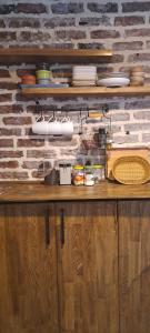 a counter with plates and other items on a brick wall at Ava House in Diyarbakır +16 photos