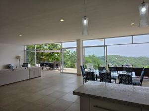 a large room with chairs and a table with a view at Villa Monte Aragón in San Agustinillo