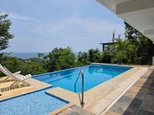 a swimming pool with a view of a house at Villa Monte Aragón in San Agustinillo