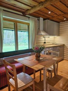 a kitchen with a wooden table and a dining room at 2-bedroom, fenced yard, sauna, 10 min to Pärnu in Pärnu +38 photos