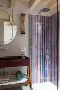 a bathroom with a shower with a sink and a mirror at Le Dimore di Rosa e Vincenzo in Bari +34 photos