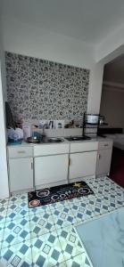 a kitchen with a sink and a tile floor at Independent Apartment in Antananarivo in Antananarivo