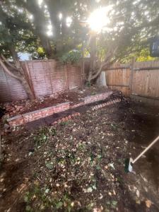 a backyard with a wooden fence and a bench at Harrow and Wealdstone studio in Harrow +1 photo