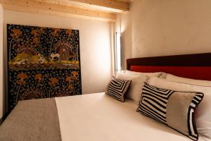 a bedroom with a bed with a tapestry on the wall at Le Dimore di Rosa e Vincenzo in Bari