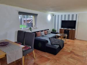 a living room with a couch and a table at Natur in Blankenhain
