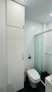 a bathroom with a toilet and a glass shower at Studio 714 - Flamengo in Rio de Janeiro +10 photos