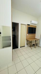 a room with a table and a kitchen with a tiled floor at Studio 714 - Flamengo in Rio de Janeiro