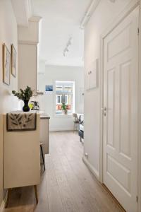 a hallway with a white door and a kitchen at Central and modern in Tromsø