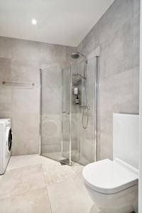 a bathroom with a shower and a toilet at Central and modern in Tromsø +10 photos