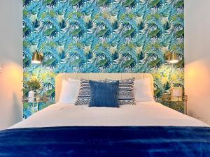 a bedroom with a bed with a blue and green wallpaper at SPECIAL OFFER - Luxury High Rise Downtown Miami - Bay Views and Top Amenities in Miami