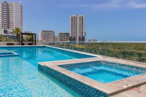 a swimming pool on the roof of a building at Condo Blue Lagoon Cancun-Espectacular Vista in Cancún