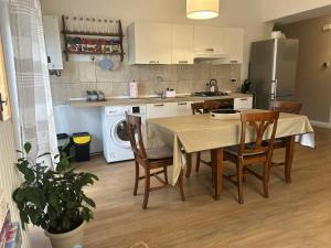 a kitchen with a table and chairs and a kitchen with a refrigerator at La Sosta del Viaggiatore in Sulmona