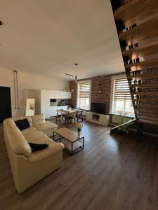 a living room with a couch and a table at Dream Apartment in Liepāja