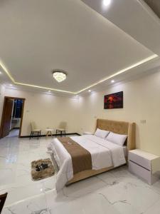 a bedroom with a large bed and two chairs at Kidy Guest House in Addis Ababa