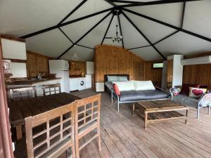 a living room with a couch and a table at İncir Bungalov Karavan Park Efes-Kuşadası in Aydın