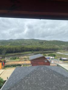 a view of a barn from the roof of a house at Condominio Bucalemu in Bucalemu +1 photo