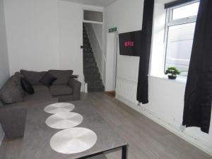 a living room with a couch and a table at La Casa de Class - Luxury & Comfort in Cardiff
