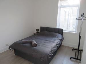 a bed sitting in a bedroom with a window at La Casa de Class - Luxury & Comfort in Cardiff