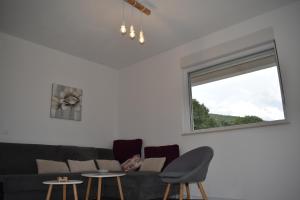 a living room with a couch and a window at Suncrest in Mostar