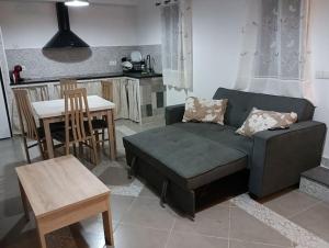 a living room with a couch and a table at Sweet hause carril 23 in Caravaca de la Cruz