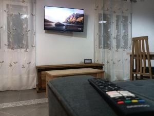 a living room with a tv on the wall at Sweet hause carril 23 in Caravaca de la Cruz