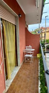 a patio with a table and chairs on a balcony at Domus Maris in Marina di Ascea +3 photos