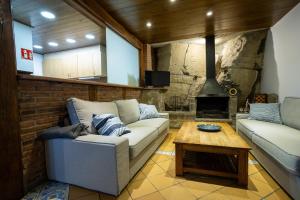 a living room with a couch and a fireplace at Casa LART RUPIT in Rupit