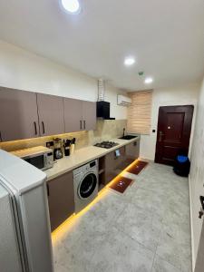 a kitchen with a washing machine in the middle of it at Dublin Unit in Maiyegun
