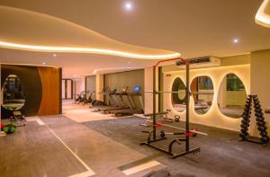 a gym with a bunch of exercise equipment in it at Tulum Getaway with Jacuzzi & Pools in Tulum