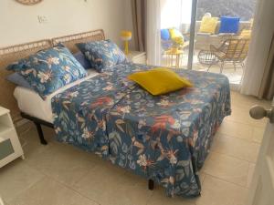 a bedroom with a bed with a colorful bedspread at Mogán Vista Bonita in Mogán +30 photos