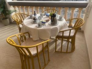 a table with a white table cloth and chairs at Mogán Vista Bonita in Mogán