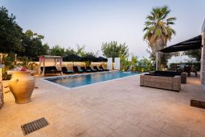 a swimming pool with lounge chairs and a resort at Villa Splendide in Rhodes Town