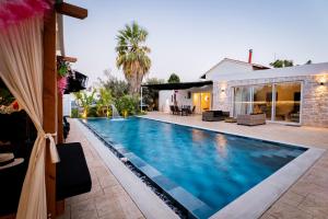 a swimming pool in the backyard of a house at Villa Splendide in Rhodes Town