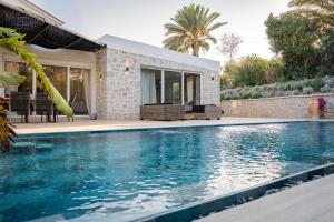 a swimming pool in front of a house at Villa Splendide in Rhodes Town
