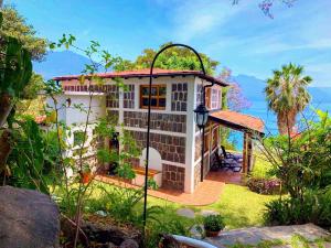 a house with a view of the ocean at Lakefront Villa with Beach Access & Infinity Pool in San Pedro La Laguna