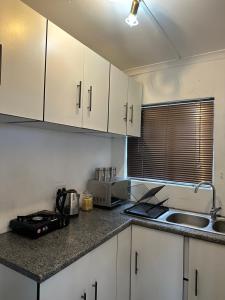 a kitchen with white cabinets and a counter top at The Tranquil Ridge in Hilton