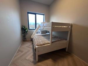 a bunk bed in a room with a window at Golden circle luxury villa in Grímsnes og Grafningshreppur