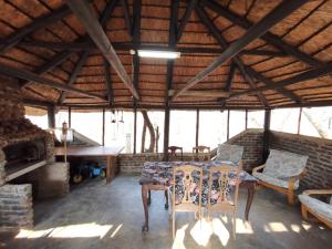 a dining room with a table and chairs in a building at Chip n Debs Kruger Vacations in Marloth Park