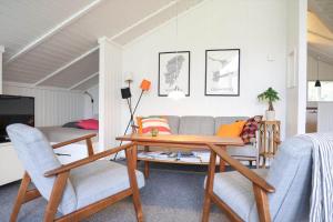a living room with a couch and a table and chairs at 13337-1-Hojby-Annettevaenget-8 in Højby