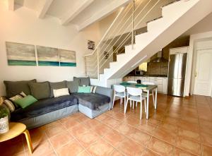 a living room with a couch and a table at Cotillo Relax in El Cotillo